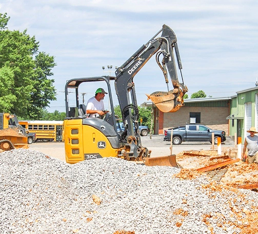 Man working on a mini excavator